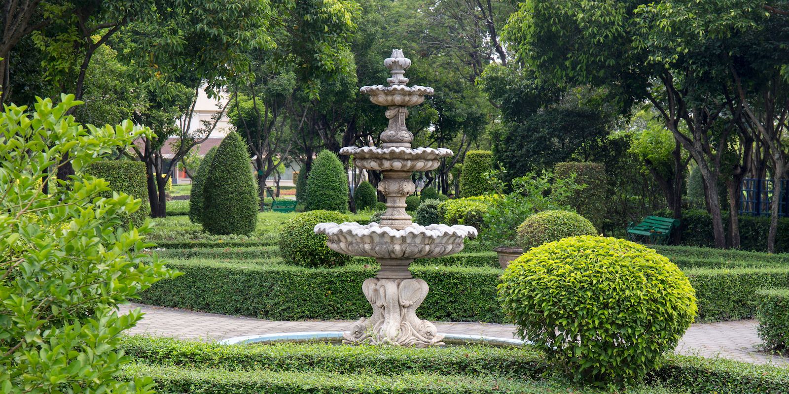 3 tier concrete fountain surrounded by trees