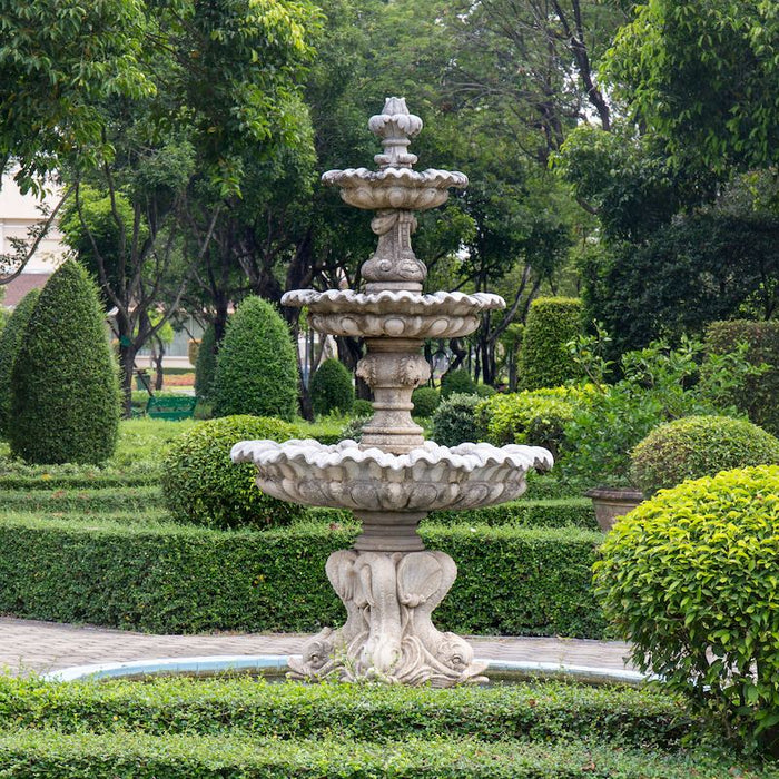 3 tier concrete fountain surrounded by trees