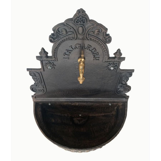 A cast iron wall fountain viewed from above.