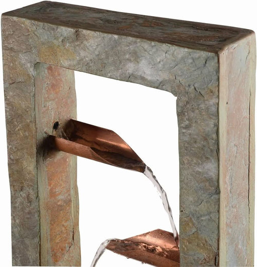 Slate water fountain close-up showing copper spouts with water cascading between levels.