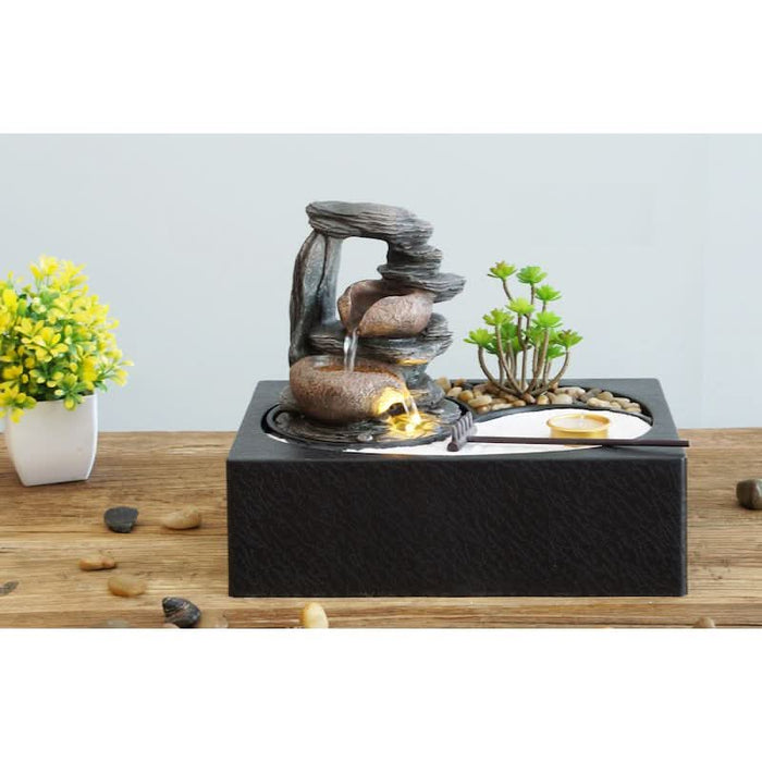 A tabletop water fountain with 2 bowls.
