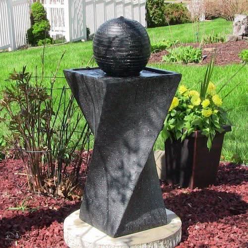 twist shaped outdoor fountain in garden