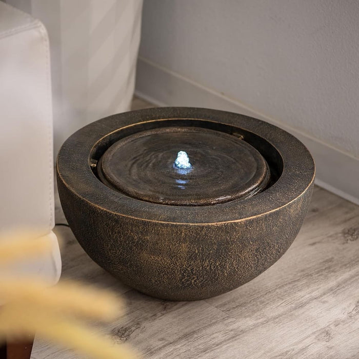 Bronze colour bowl water feature in the living room.