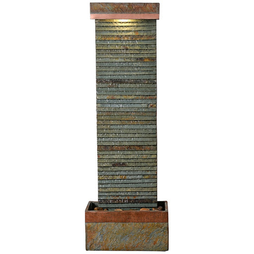 Full view of tall slate water fountain with ribbed stone texture, copper trim, and warm LED lighting at the top.