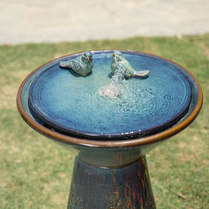 Close up view of the top of a ceramic birdbath fountain.