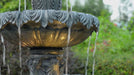 3-tier fountain with water flowing from middle bowl