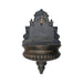 A cast iron wall fountain with water tap spout.