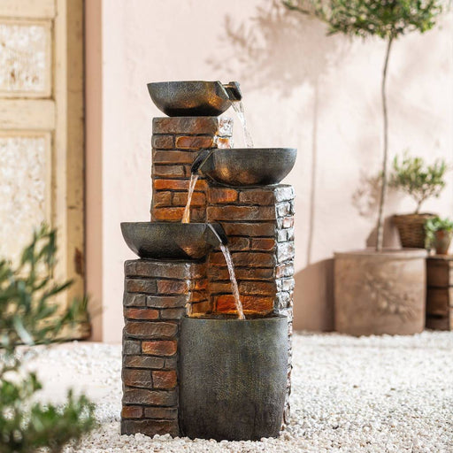 Pots and bricks themed fountain outdoors.