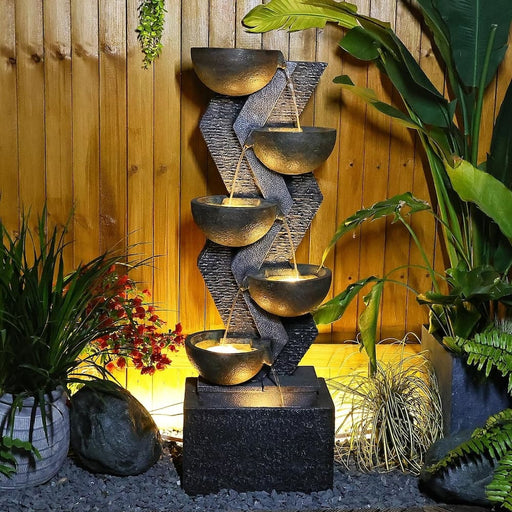 A 6-tier water feature with LED lights at night.