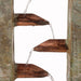 Close-up of copper spouts on a slate water fountain with water flowing between tiers.