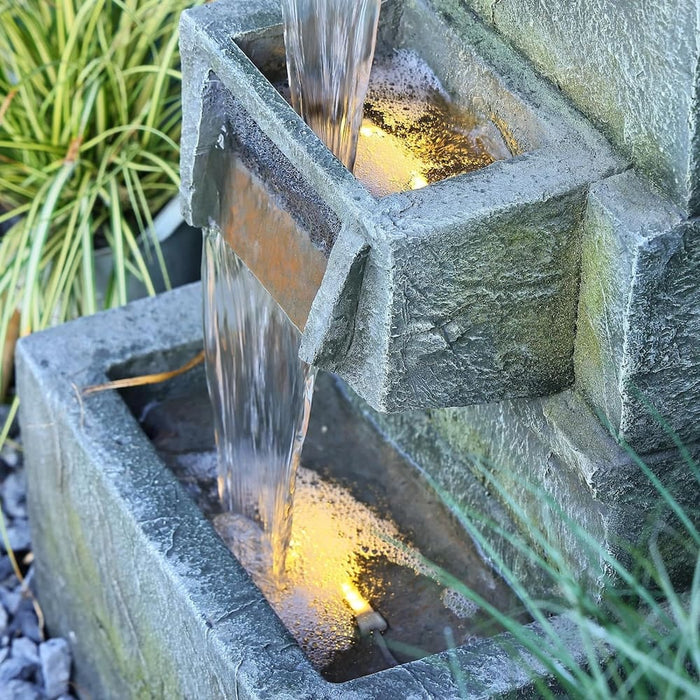 A closeup view of a wall fountain's square bowls.