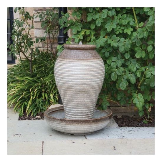 A vase-shaped water feature in the garden.