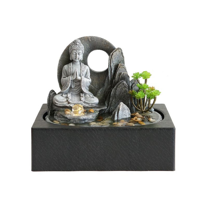 A tabletop fountain showing a Buddha in meditation.
