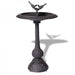 A black bird bath made from cast iron.