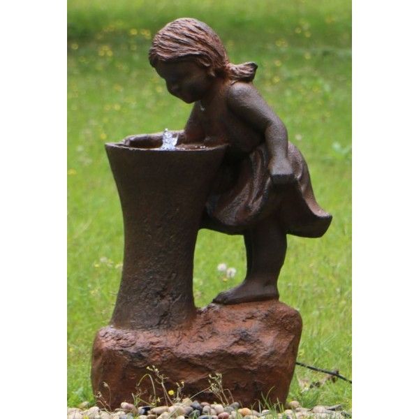 A water feature depicting a girl drinking from a tap.