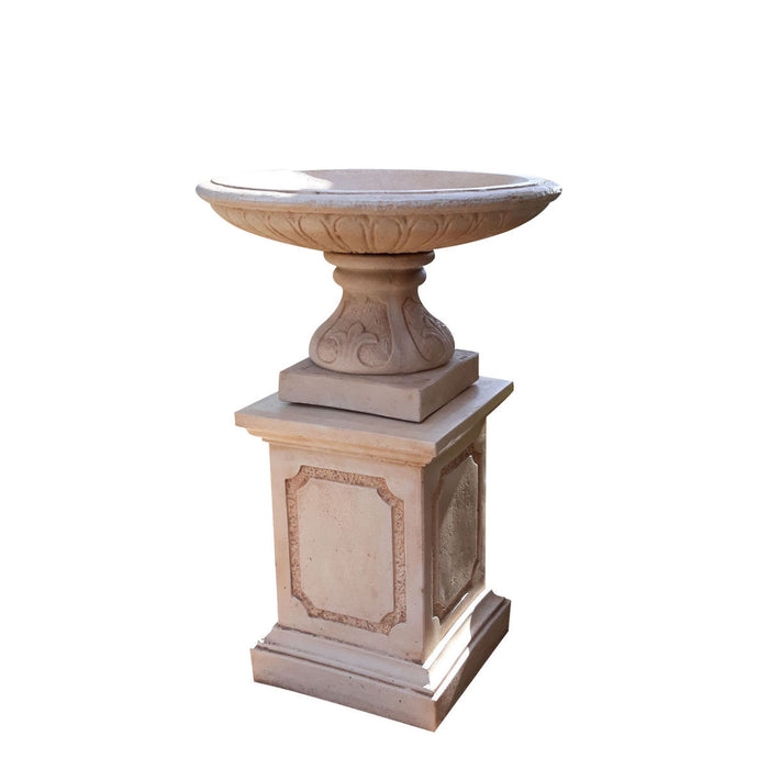 A large bird bath fountain in sandstone.